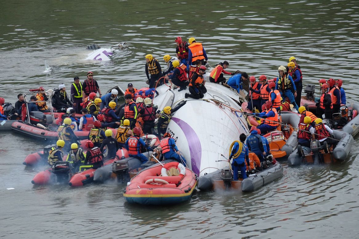 Rescuers work to free people from the wreckage in the Keelung River on February 4.