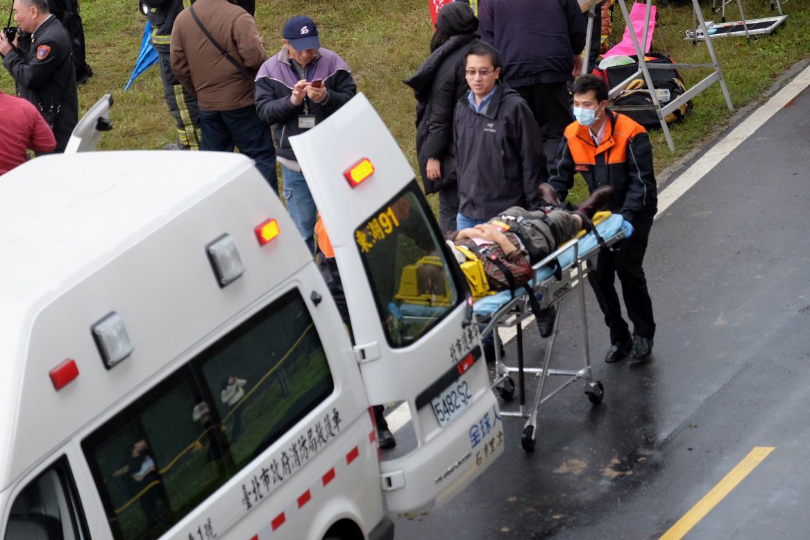 Rescue personnel put an injured passenger into an ambulance on February 4. 