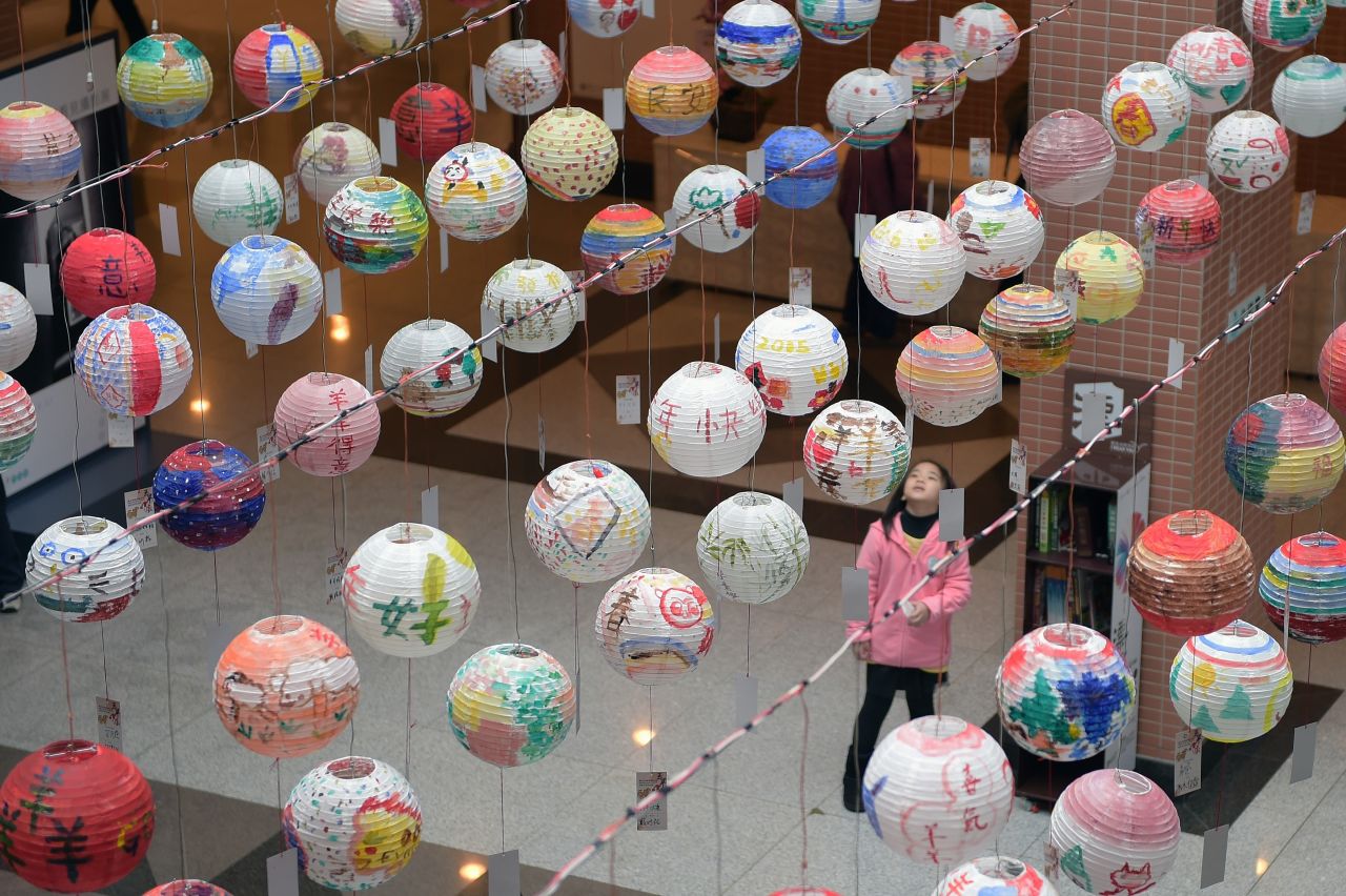 A girl admires painted lanterns during a festival in New Taipei City, Taiwan, on Saturday, January 31. 