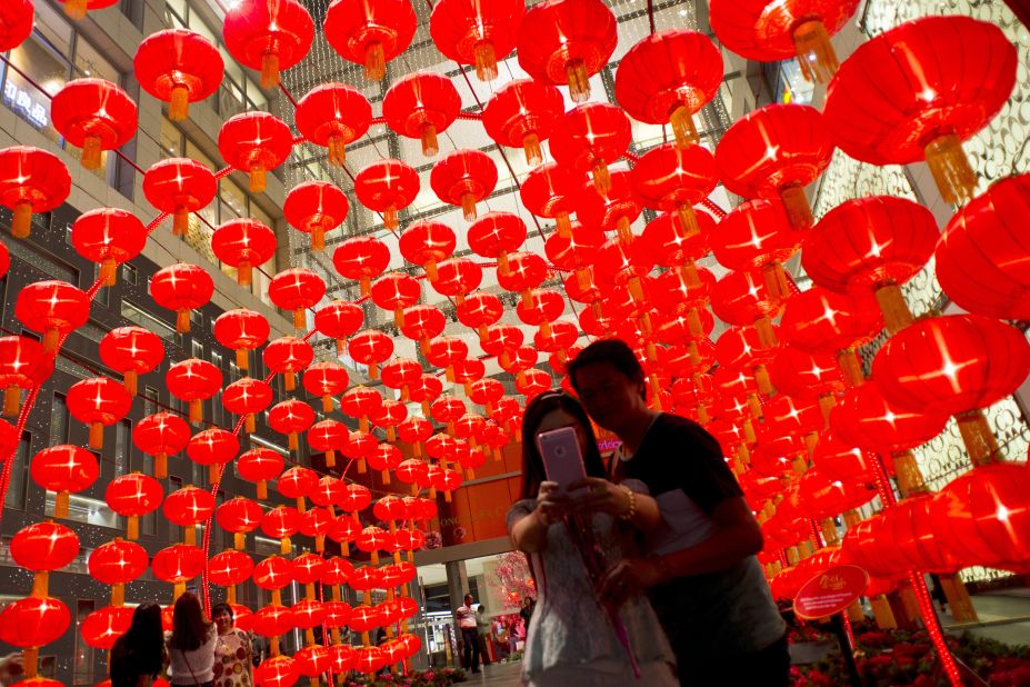 A couple takes a selfie against traditional Chinese lanterns at a shopping mall in Kuala Lumpur, Malaysia, on Wednesday, January 28.