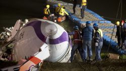 Rescuers lift the wreckage of the TransAsia ATR 72-600 oot of the Keelung river at New Taipei City on February 4, 2015.