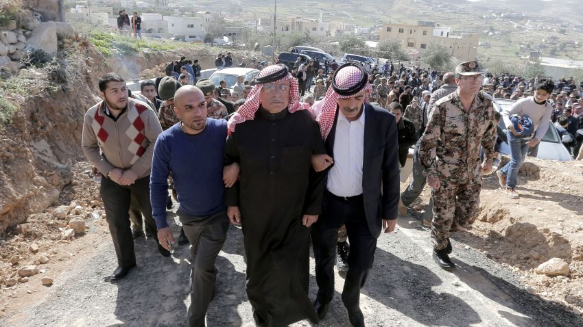 Safi (C), the father of Jordanian pilot Maaz al-Kassasbeh, who was killed by Islamic State (IS) group militants on February 3, 2015 after he was captured by IS when his plane went down in Syria in December, is surrounded by family members and security forces during a mourning ceremony at the headquarters of the family's clan in the Jordanian city of Karak on February 4, 2015. Jordan executed two death-row Iraqi jihadists, including a woman, on February 4 after vowing to avenge the burning alive of its fighter pilot Maaz al-Kassasbeh. Jordan had promised to begin executing Islamic extremists on death row in response to the murder of the pilot. AFP PHOTO / KHALIL MAZRAAWIKHALIL MAZRAAWI/AFP/Getty Images