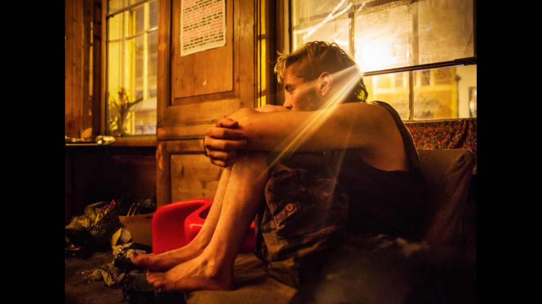 A squatter sits in the living room of a London squat called "Borough High Street." Photographer Corinna Kern visited several squats in the capital city.