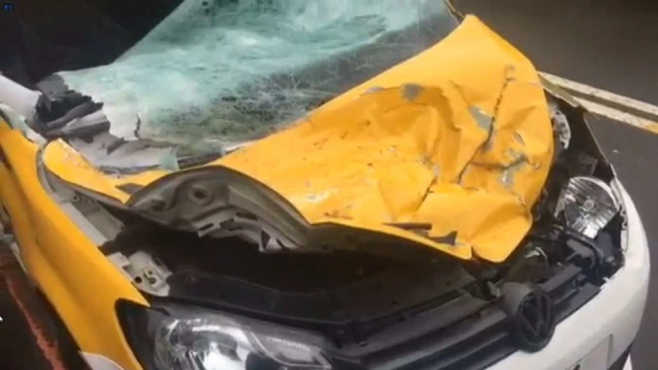 A taxi was hit by the plane as it clipped an elevated highway.
