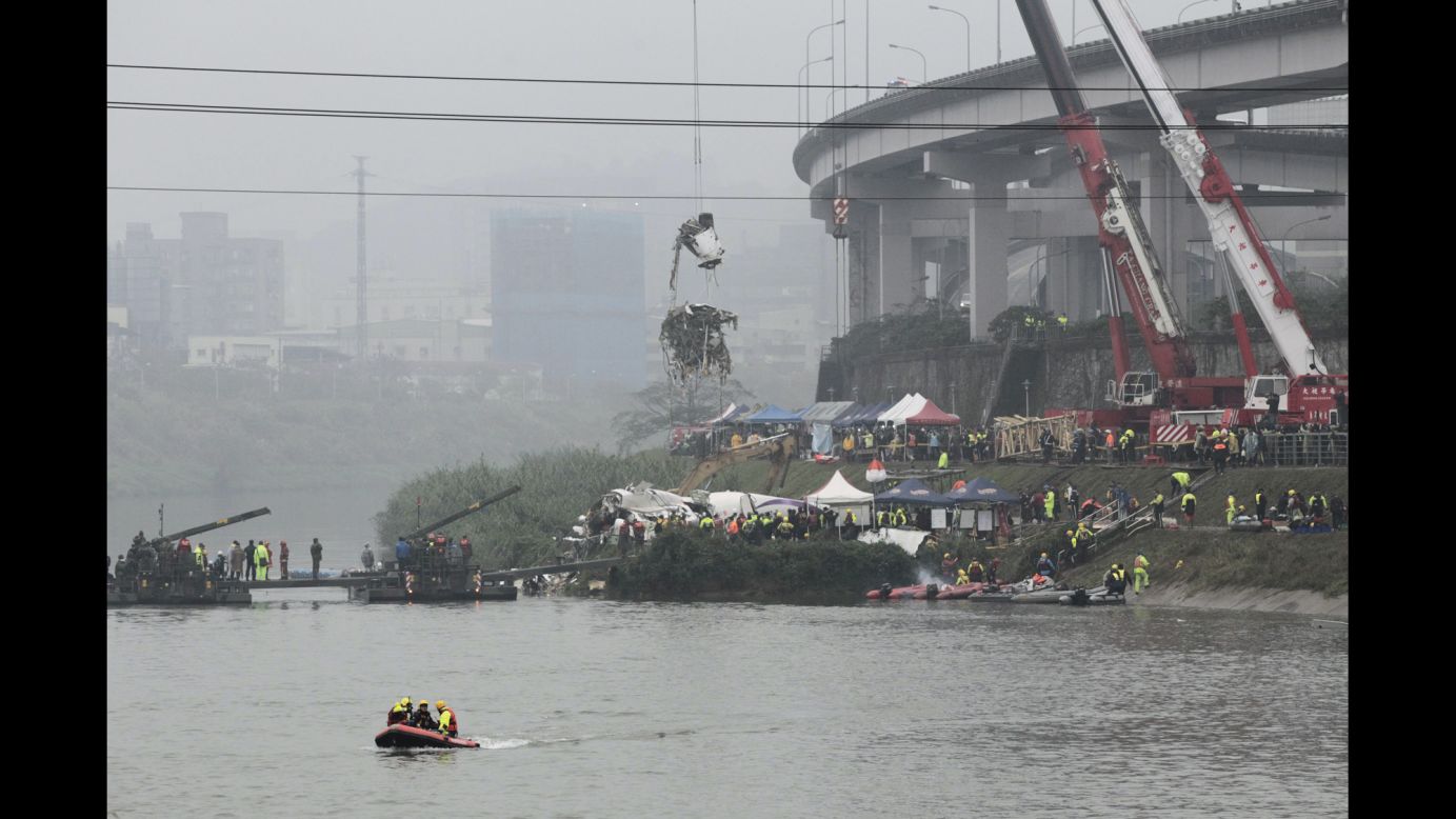 A crane lifts part of the wreckage at the crash site in Taipei on Thursday, February 5.