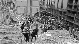 (FILE) Firemen and policemen search for wounded people after a bomb exploded at the Argentinian Israelite Mutual Association (AMIA) in Buenos Aires, 18 July 1994.The Jewish community in Argentina expressed vehement opposition on January 28, 2013 to Argentina and Iran's agreement to create a "truth commission" to probe a 1994 bombing of a Jewish center that killed 85 people. On Sunday, President Cristina Kirchner announced a deal with Tehran for a probe by a commission composed of five independent judges -- none of whom would be from either Iran or Argentina.   AFP PHOTO/Ali BURAFI        (Photo credit should read ALI BURAFI/AFP/Getty Images)