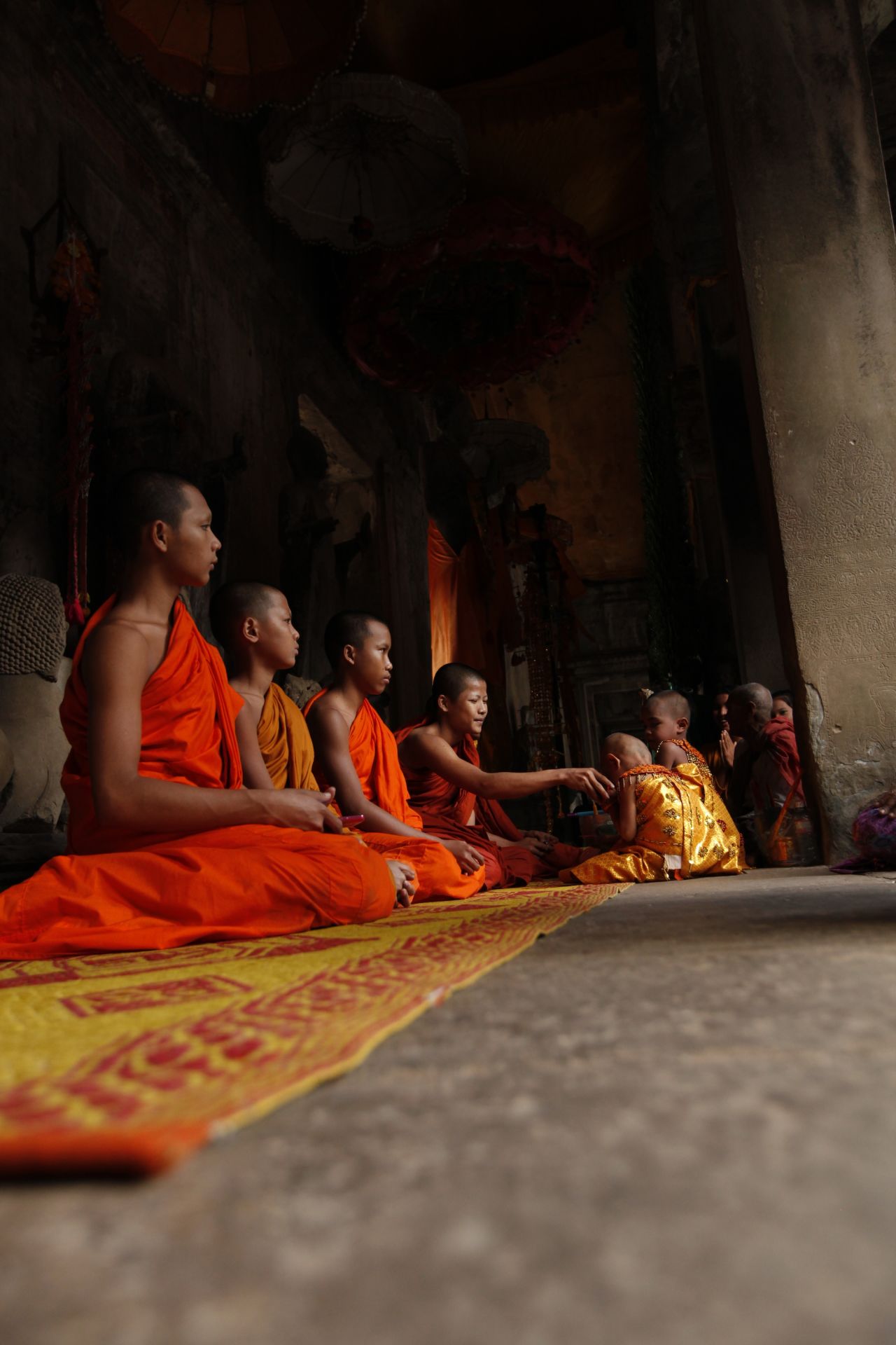Monks from the nearby temple can often be seen conducting Buddhist ceremonies inside Angkor Wat. 