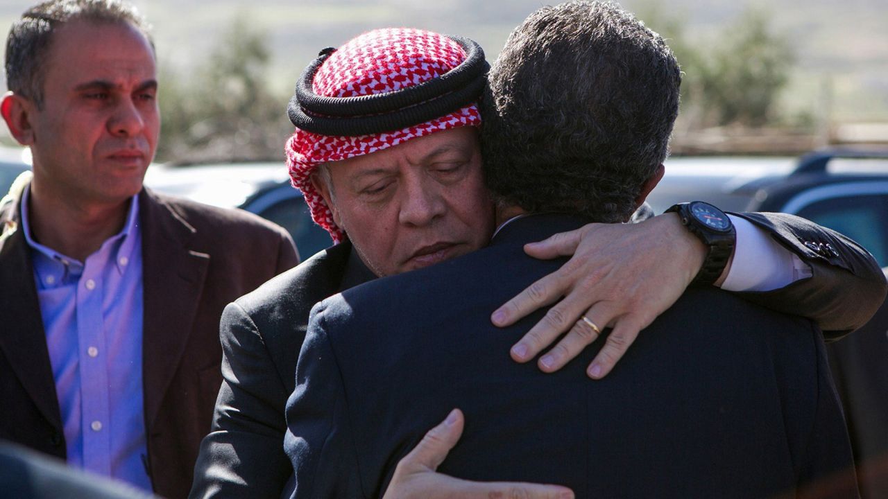 Jordan's King Abdullah II, center, greets a relative of al-Kasasbeh's while paying his condolences on Thursday, February 5.