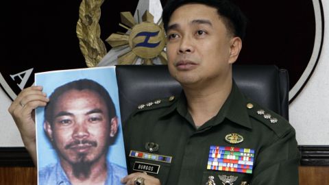 A Philippines Armed Forces spokesman shows a picture of Zulkifli bin Hir, also known as Marwan, in 2012.