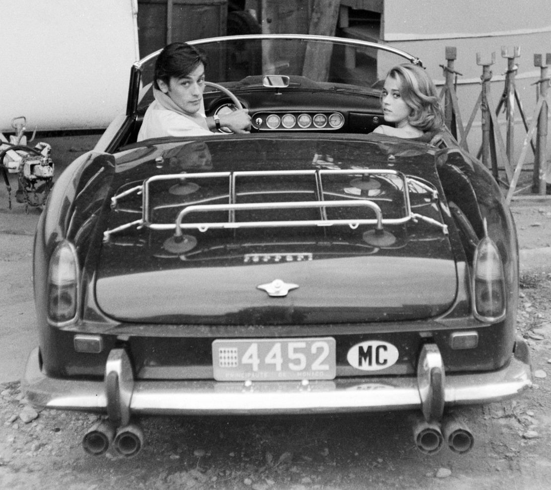 Actors Alain Delon (left) and Jane Fonda (right) in the rare Ferrari California Spider during the filming of Les Felins in 1964