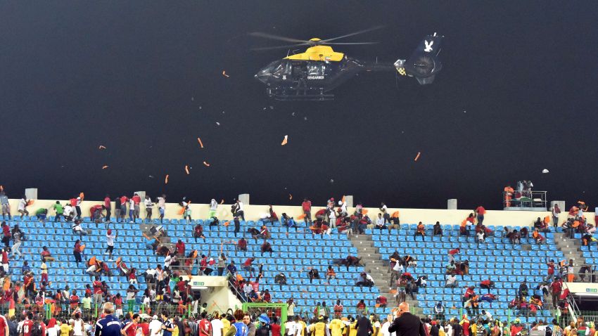 A police helicopter flies over the statdium during an interruption of the 2015 African Cup of Nations semi-final football match between Equatorial Guinea and Ghana in Malabo, on February 5, 2015. Play was halted eight minutes from time in the Africa Cup of Nations semi-final between hosts Equatorial Guinea and Ghana when missiles were thrown on the pitch. AFP PHOTO / ISSOUF SANOGOISSOUF SANOGO/AFP/Getty Images