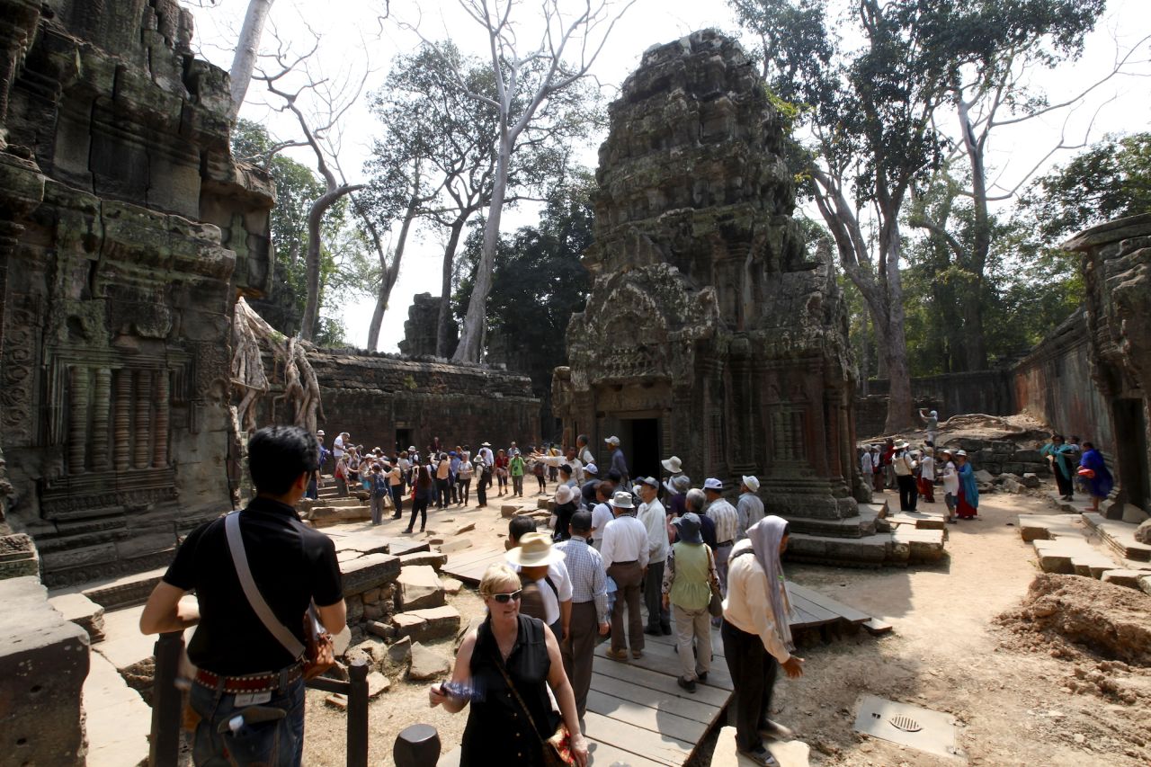You didn't think you'd have the place to yourself, did you? Thanks to a little-known actress called Angelina Jolie and the film "Tomb Raider," this Angkor temple, famed for the large fig, banyan and kapok trees that are 'choking' the ruins, endures the bulk of visitors to the area. 