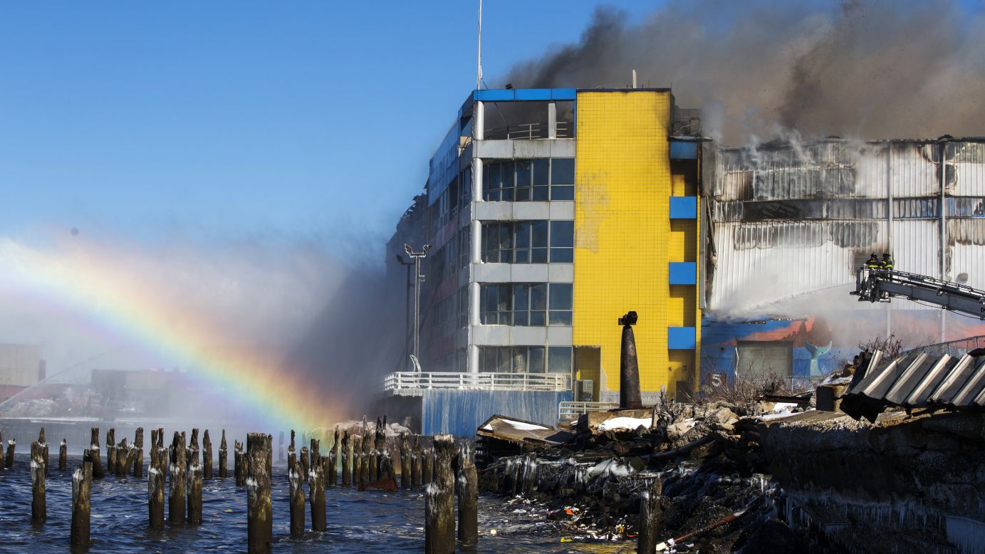 Members of the New York Fire Department battle a six-alarm fire at a storage facility on the waterfront of the East River on Saturday, January 31.