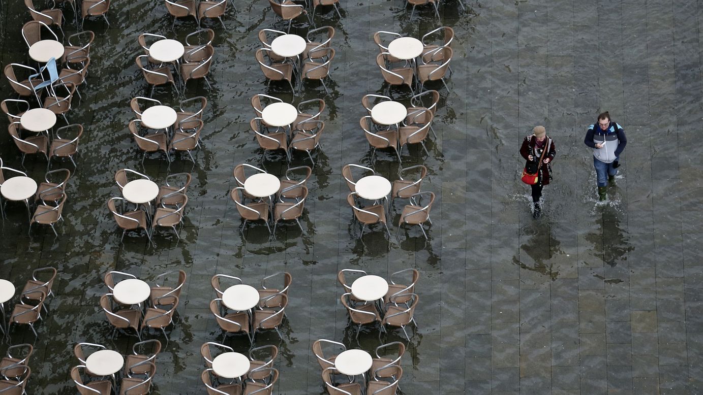 People in Venice, Italy, walk on a flooded St. Mark's Square on Sunday, February 1.