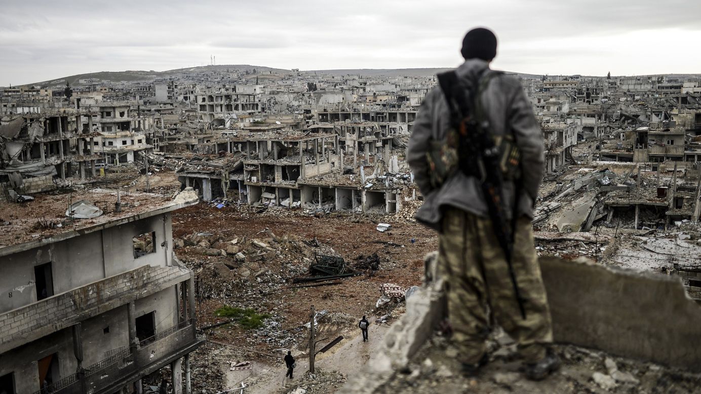 A Kurdish marksman looks over a destroyed area of Kobani, Syria, on Friday, January 30, after the city had been liberated from the ISIS militant group. Kobani, also known as Ayn al-Arab, <a href="http://www.cnn.com/2014/06/13/world/gallery/iraq-under-siege/index.html" target="_blank">had been under assault by ISIS</a> since mid-September. <a href="http://www.cnn.com/2015/01/30/world/gallery/week-in-photos-0130/index.html" target="_blank">See last week in 32 photos</a>