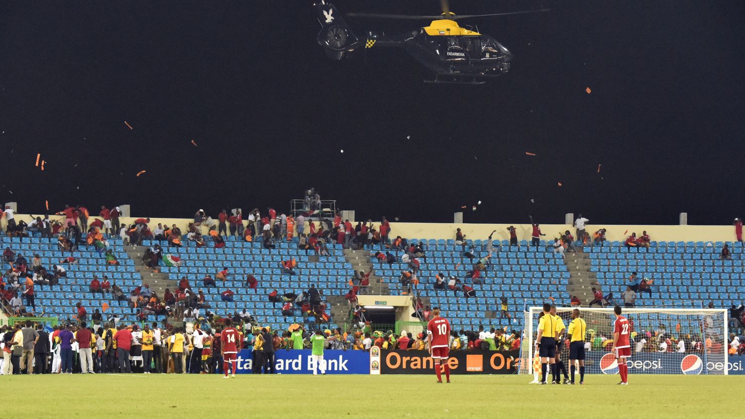 A police helicopter flies over the stadium during an interruption of the 2015 African Cup of Nations semi-final football match between Equatorial Guinea and Ghana in Malabo, on February 5, 2015. Play was halted eight minutes from time in the Africa Cup of Nations semi-final between hosts Equatorial Guinea and Ghana when missiles were thrown on the pitch.
