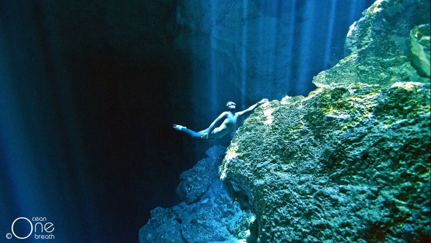Christina, pictured, looks to the surface while clinging to the limestone bedrock of a ceynote, a natural underwater cavern in Mexico. A healthy lifestyle is vital to a life of freediving but for the duo, it comes fairly naturally. "We always go to the gym and we spend a lot of time in the water because the best training for freediving is freediving itself. With that comes a healthy lifestyle so we are always watching our diets, and when you're training, you feel like staying very healthy anyway."<br />