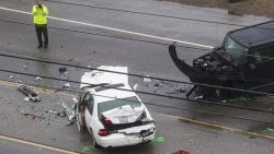 A Los Angeles County Sheriff's department investigates the scene of a collision involving three vehicles in Malibu, Calif. on Saturday, Feb. 7, 2015. Officials said former Olympian Bruce Jenner was a passenger in one of the cars involved in the Pacific Coast Highway crash that killed one person. Jenner's publicist, Alan Nierob, says Jenner was unhurt. (AP Photo/Ringo H.W. Chiu)