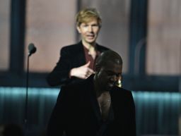 Beck, left, reacts as Kanye West leaves the stage after Beck won album of the year at the Grammys. 