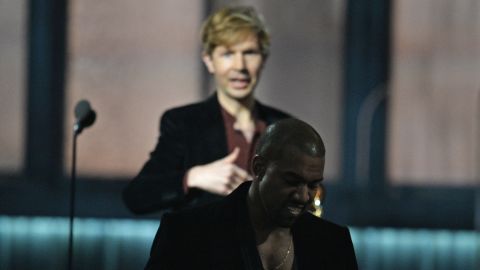 Beck, left, reacts as Kanye West leaves the stage after Beck won album of the year at the Grammys. 