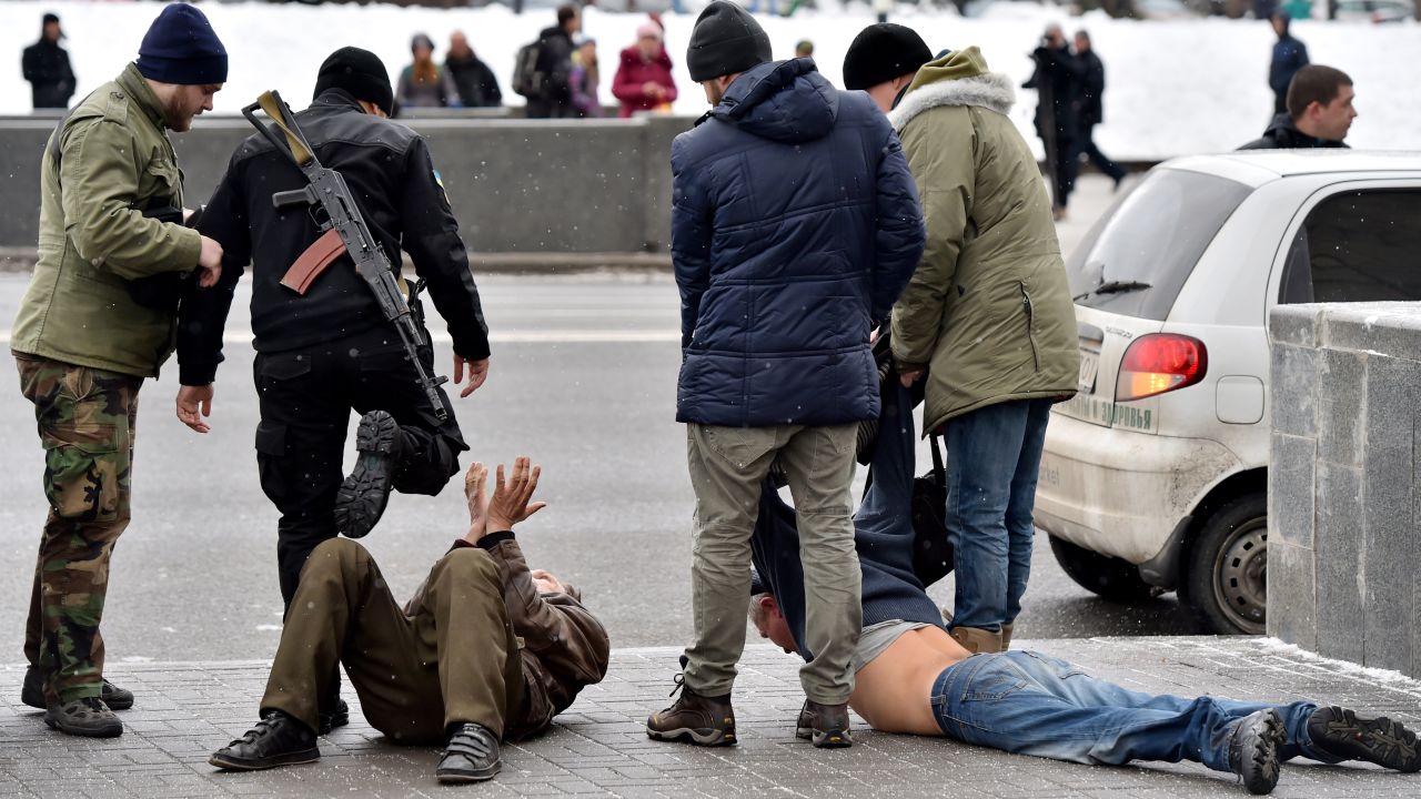 Ukrainian volunteer fighters and policemen arrest two men in Kiev, Ukraine, on February 9. The men allegedly arrived from Donetsk and were suspected of participating in pro-Russian rebel activities and organizing terrorist attacks in the Ukrainian capital.