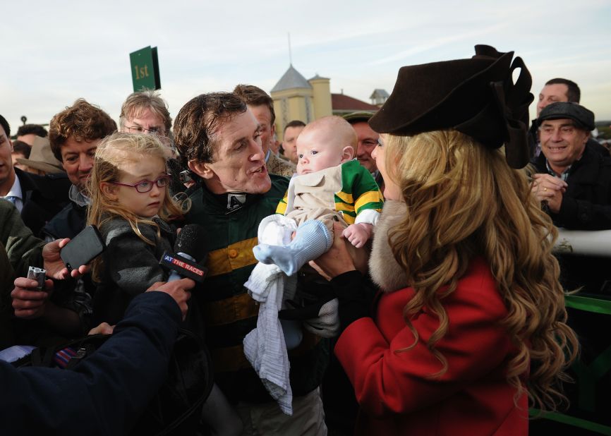 McCoy celebrates with his wife Chanelle and children Eve and Archie after being the first jump jockey past the 4,000 winners mark.