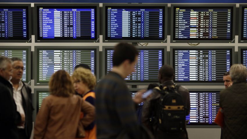Travellers stand near an information board at the Roissy-Charles-de-Gaulle airport on April 28, 2014 in Roissy-en-France, outside Paris. AFP PHOTO / KENZO TRIBOUILLARD        (Photo credit should read KENZO TRIBOUILLARD/AFP/Getty Images)