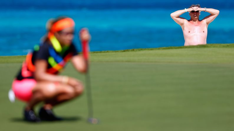 A beachgoer watches Jennifer Rosales line up a putt during the second round of the Bahamas LPGA Classic on Friday, February 6.