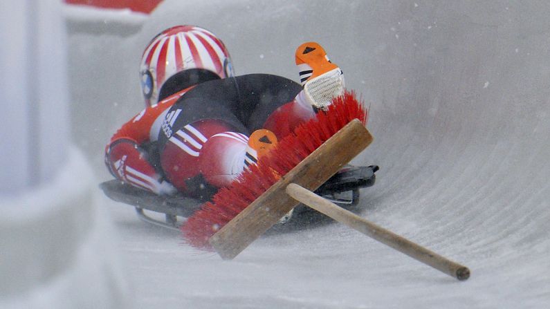 Canada's Jane Channel crashes with a broom Sunday, February 8, during a World Cup skeleton race in Igls, Austria. The broom was accidentally left behind by staff cleaning the ice.