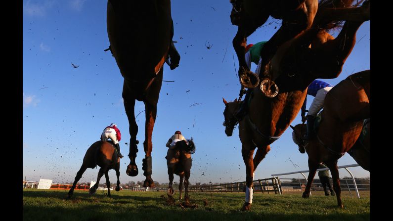 Horses jump a fence during a steeplechase race in Bangor, Wales, on Friday, February 6.