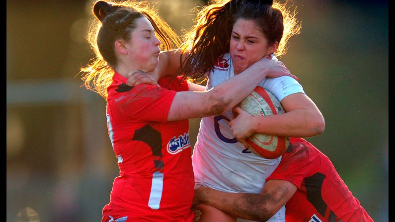 England wing Sydney Gregson is tackled by two Welsh players during a Six Nations match Sunday, February 8, in Swansea, Wales. Wales won 13-0 in what was the opening tournament match for both teams.