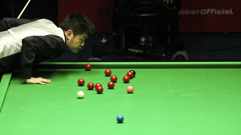 Liang Wenbo eyes the ball Saturday, February 7, while playing Shaun Murphy in the German Masters snooker tournament in Berlin. Murphy won the semifinal 6-4 and advanced to the final, which he lost to Mark Selby.