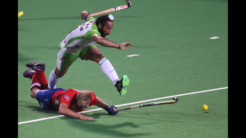 Delhi Waveriders captain Sardara Singh jumps over a Dabang Mumbai player during a field hockey match Thursday, February 5, in Mumbai, India.