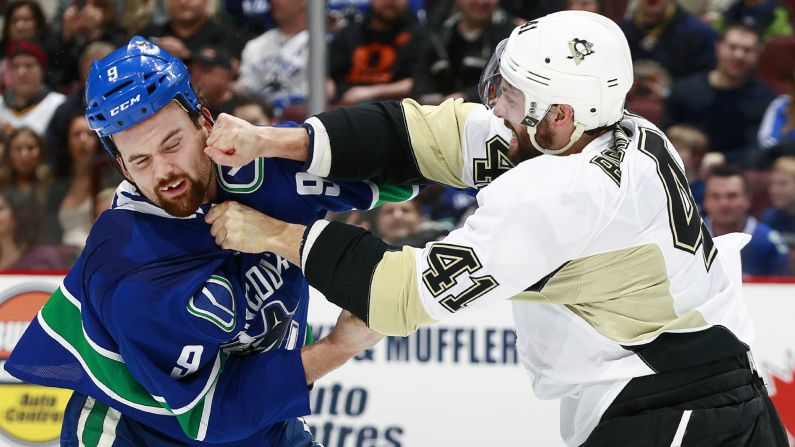 Zack Kassian of the Vancouver Canucks, left, fights Robert Bortuzzo of the Pittsburgh Penguins during an NHL game played Saturday, February 7, in Vancouver, British Columbia.