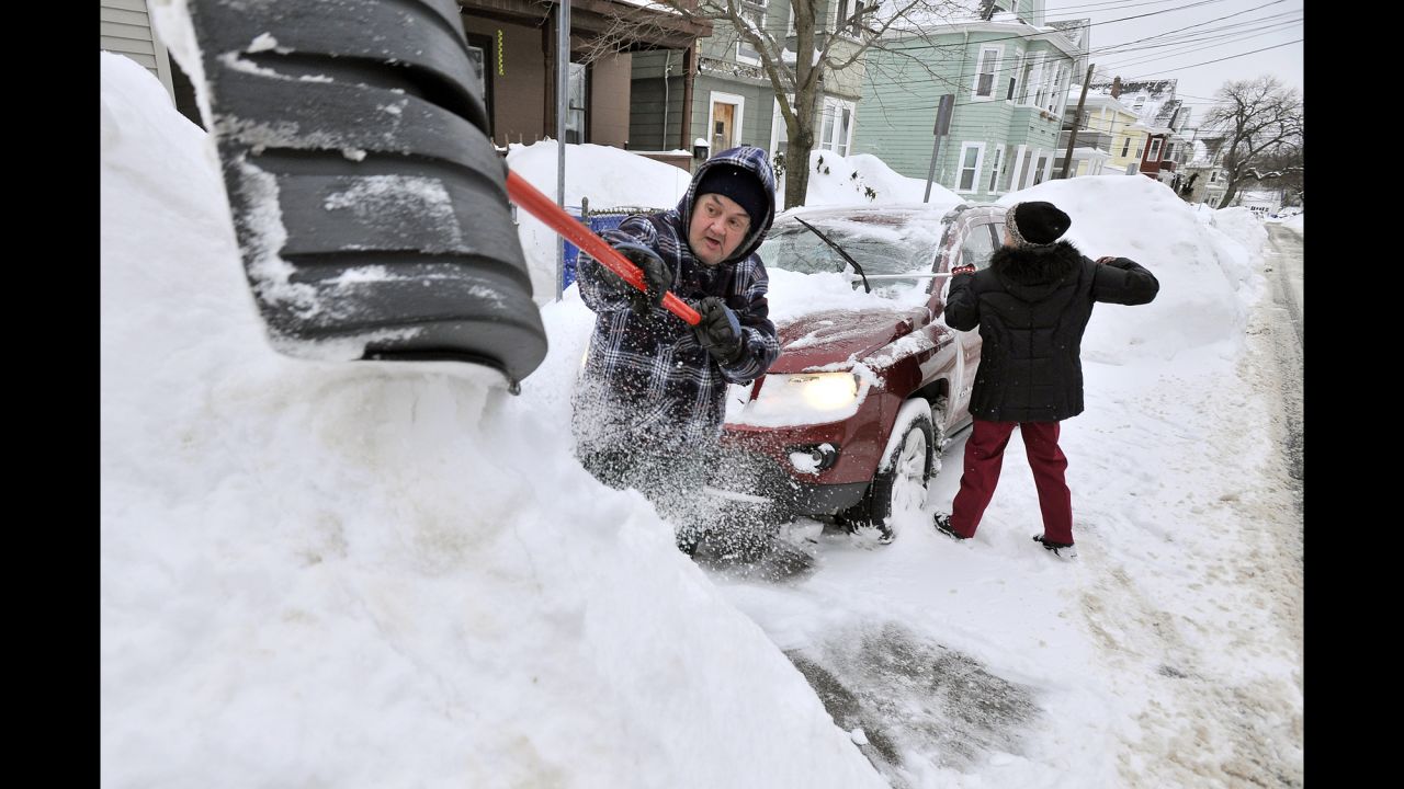Rich and Kathy Melvin shovel out their car in front of their house in Somerville, Massachusetts, on Tuesday, February 10. 