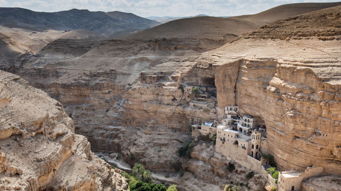 St. George's Monastery, carved into the side of a cliff near Jericho, stands alone at the bottom of Wadi Qelt, often associated with the biblical "valley of the shadow of death." 