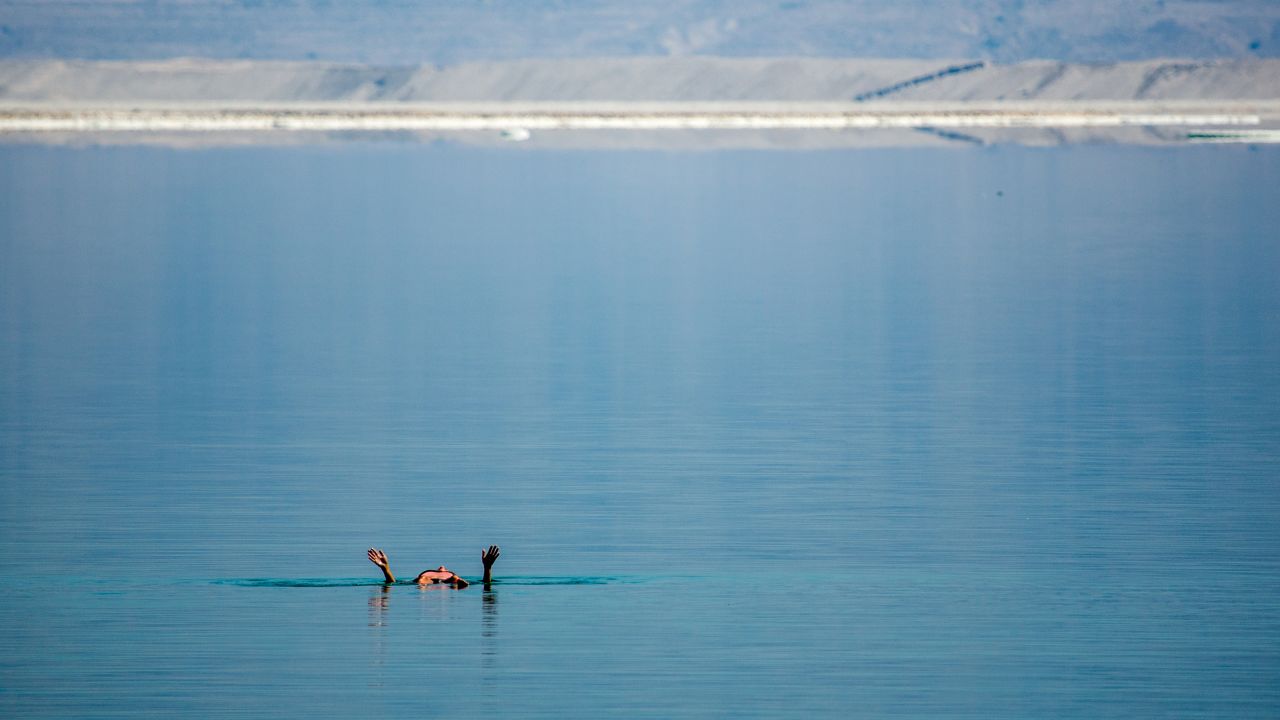 A visitor to the DMZ Medical Spa in southern Israel floats in the evaporation ponds of the Dead Sea.