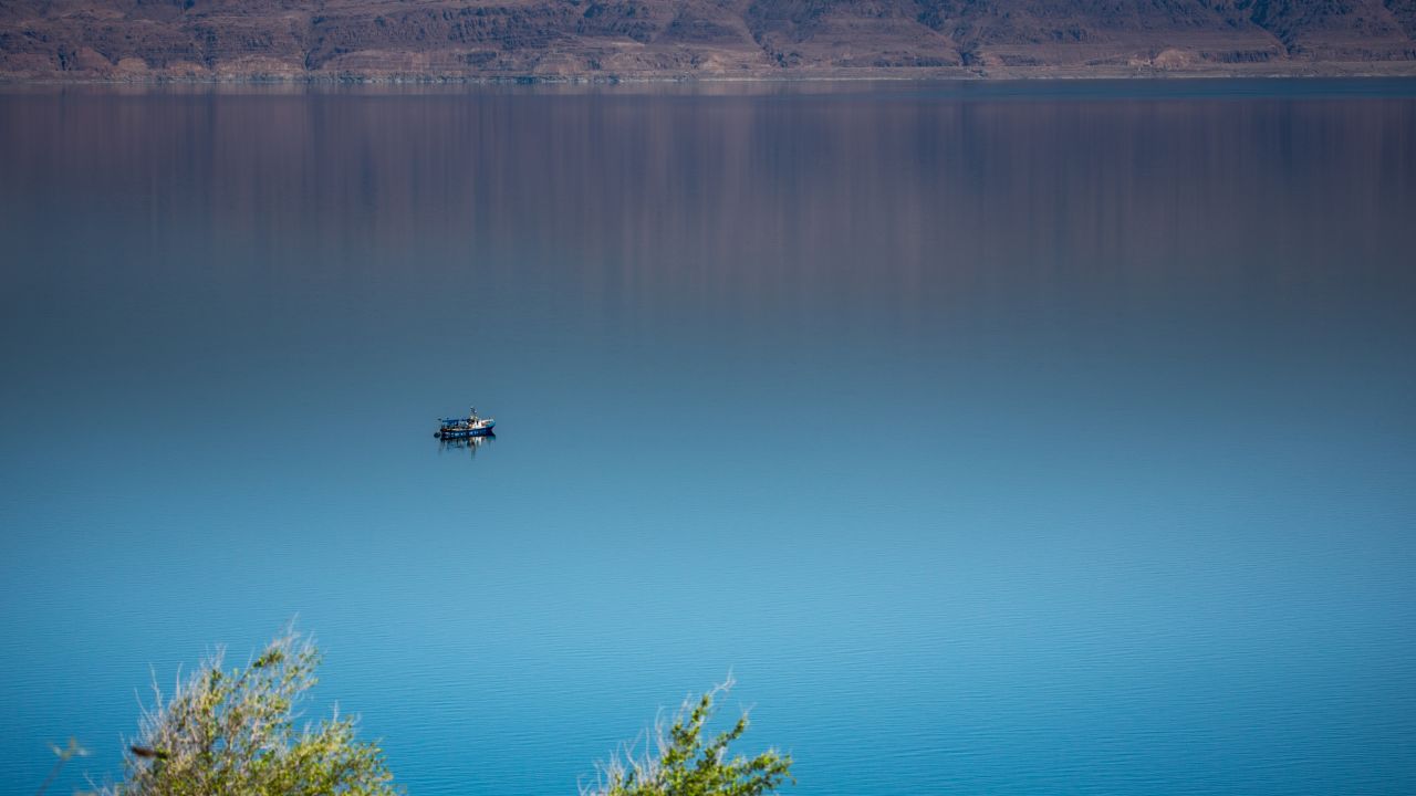 A lone ship navigates the still waters of the Dead Sea near Ein Fasha.