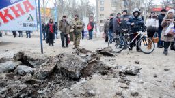 People examine a crater after shelling in eastern Ukrainian town of Kramatorsk, in the Donetsk region, on February 10, 2015. At least six civilians were killed and 21 wounded in a rocket attack on Ukraine's military headquarters in the war-torn east, local authorities said. The attack also hit residential areas of Kramatorsk, which is considered to be under firm Kiev control. AFP PHOTO / SERGEY BOBOKSERGEY BOBOK/AFP/Getty Images