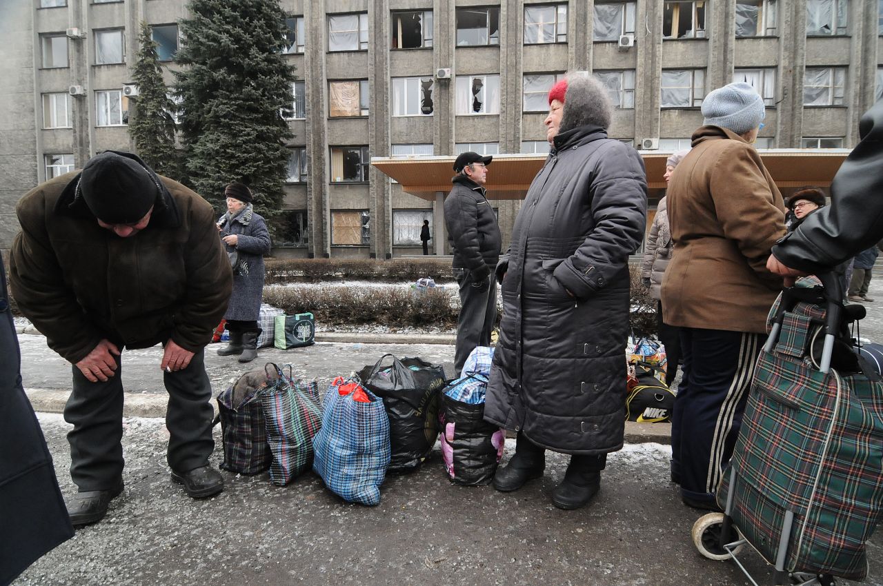 Locals wait in line for buses that will get them out of harm's way. "The city infrastructure is increasingly devastated," said a spokesman for the Ukrainian military.