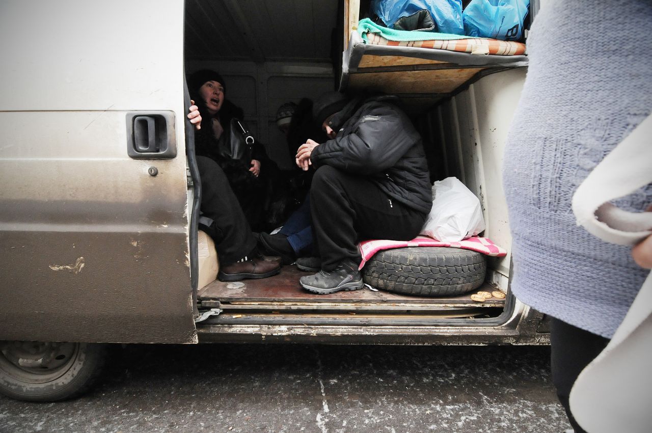 Residents jam a minivan for transport out of the besieged town. Each day, volunteers from all over Ukraine risk their lives to bring food and badly needed supplies.