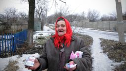 An old woman was just given some medications by volunteers who go around the town providing supplies to the last remianing civilians in the area in February 6, 2015, Debalteve, Donbass Oblast, Ukraine. About 3000 civilians are still trapped in side the besieged city of Debalteve under heavy artillery attack form Separatists forces trying to conquer this important rail way hub from Ukrainian forces defending it. While some civilians have been able to escape the city in small numbers, the road leading out of the battle zone into the closest near by safe town of Artemovsk is a very dangerous road as it is often shelled by separatists forces.