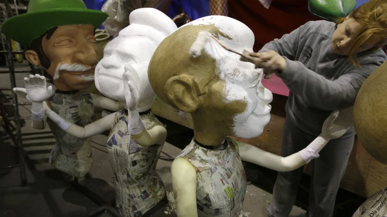 A woman paints a figure during preparations for the Carnival parade in Nice, France, on Thursday, February 5.