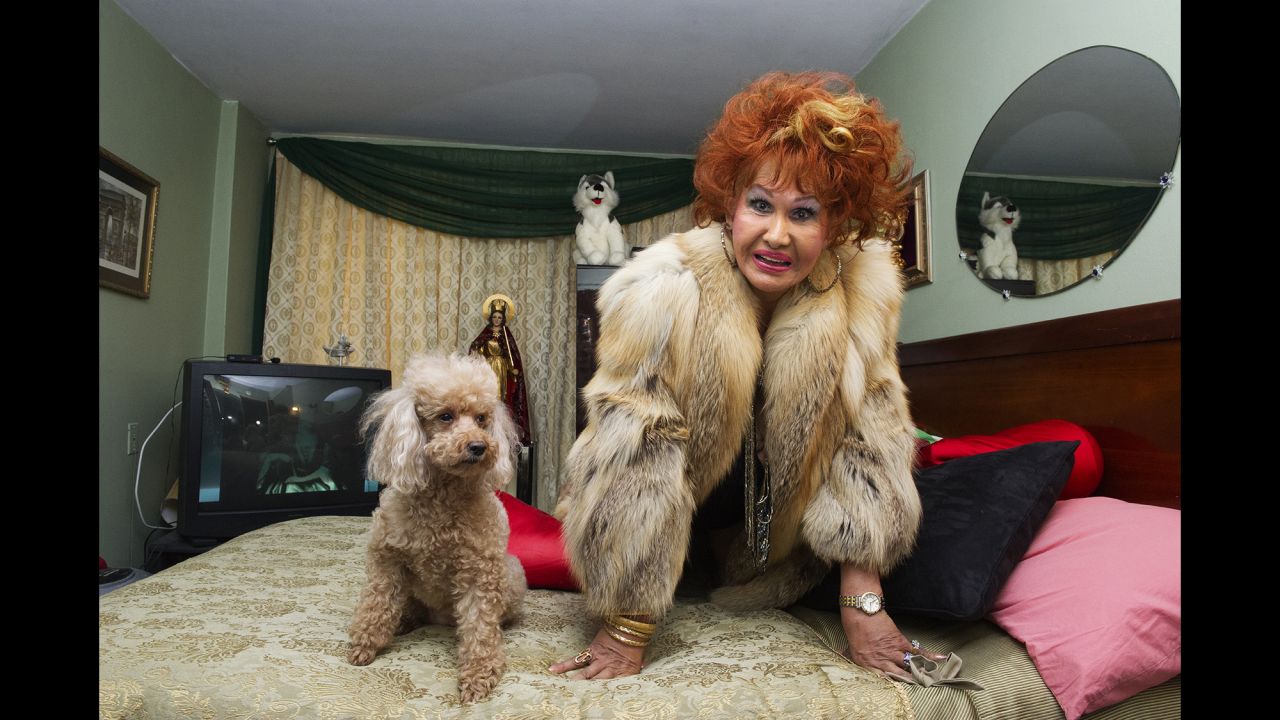 Sometimes, the women's pets would become "extras" in the photographs. Here, Suzette Fontaine strikes a suggestive pose with her dog in New York in 2014.