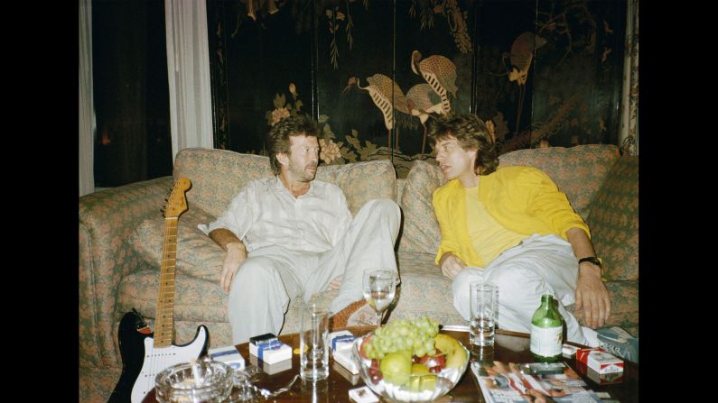 Clapton and Mick Jagger chat backstage on a couch at Philadelphia's JFK Stadium before the Live Aid concert.