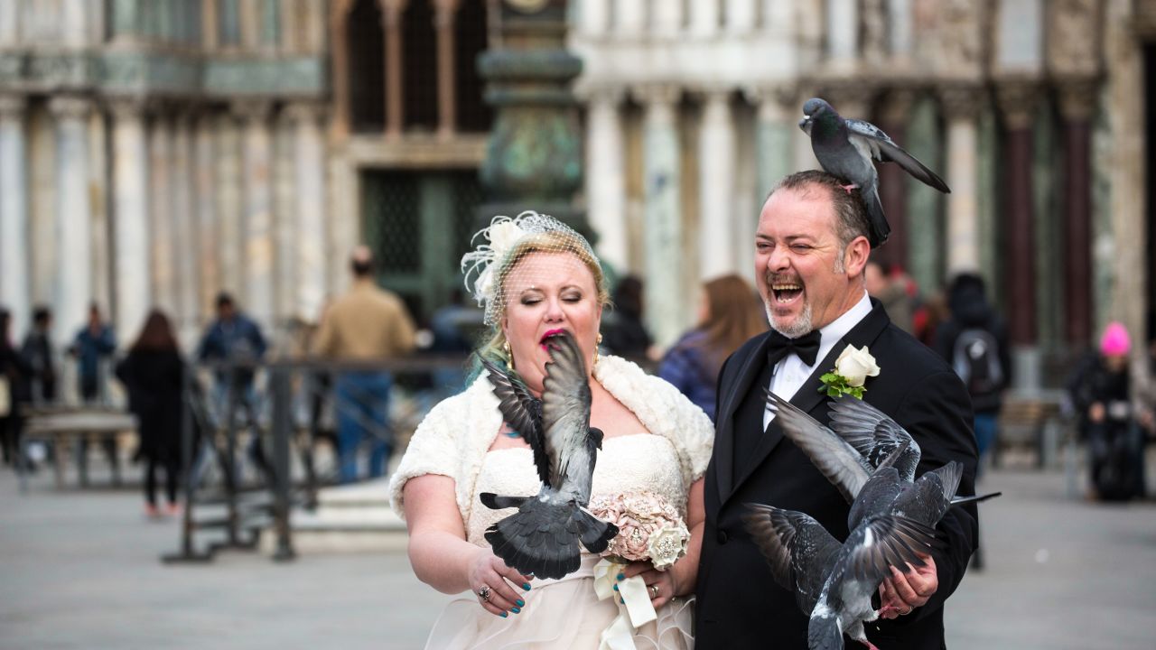 Newlyweds celebrate with the pigeons of St. Mark's Square.