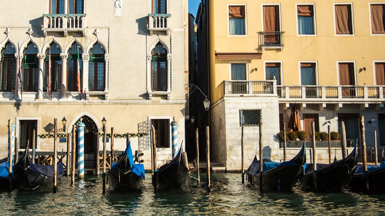 Gondolas are lined up along the banks of the Grand Canal.