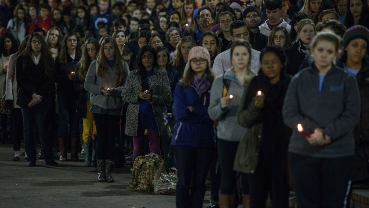 People listen during a vigil at UNC Chapel Hill in February 2015.