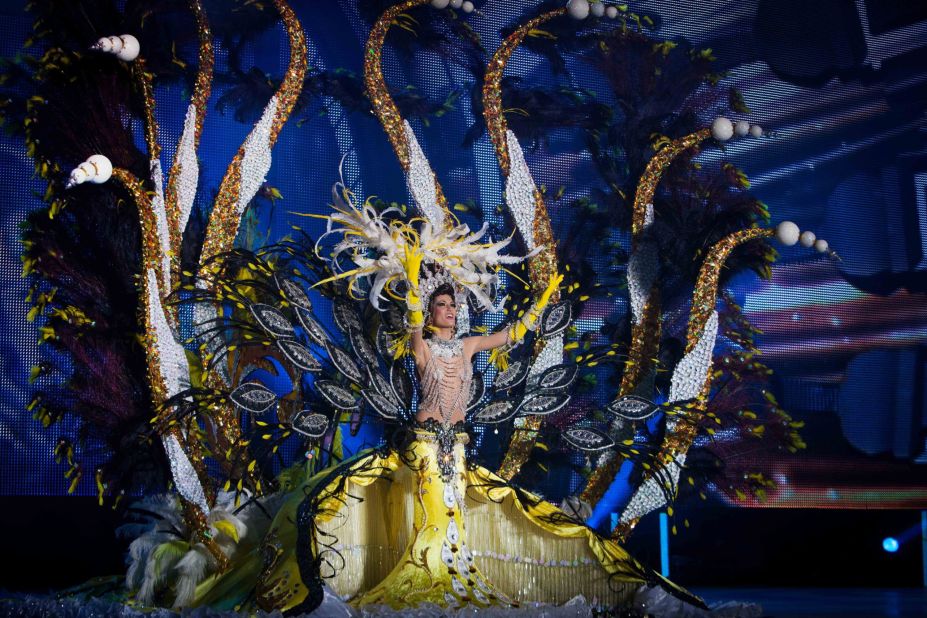 A nominee for Queen of the Carnival of Santa Cruz shows off her outfit on stage Wednesday, February 11, in Santa Cruz de Tenerife, Spain.