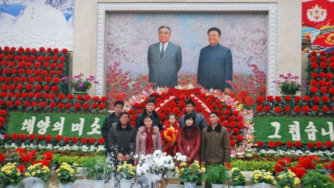 Families frequently pose for photos with the portrait of regime founder Kim Il Sung (left) and his son, Kim Jong Il (right) at a flower show in Pyongyang celebrating Kim Jong Il's birthday. Commemorated in similar fashion, the birthday of Kim Il Sung is known as the Day of the Sun and falls on April 15.